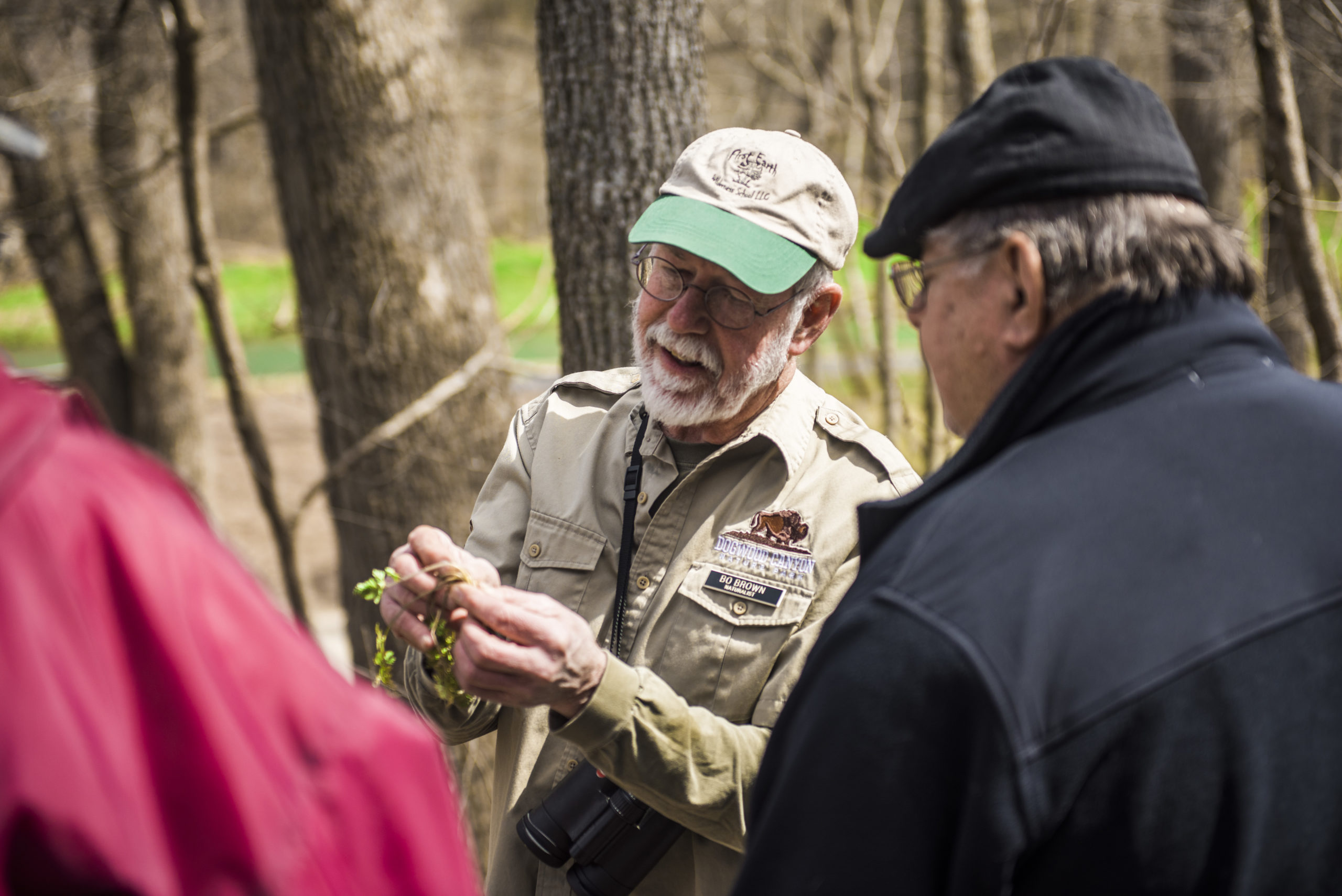 Bo Brown showing guests a small plant in his hands.